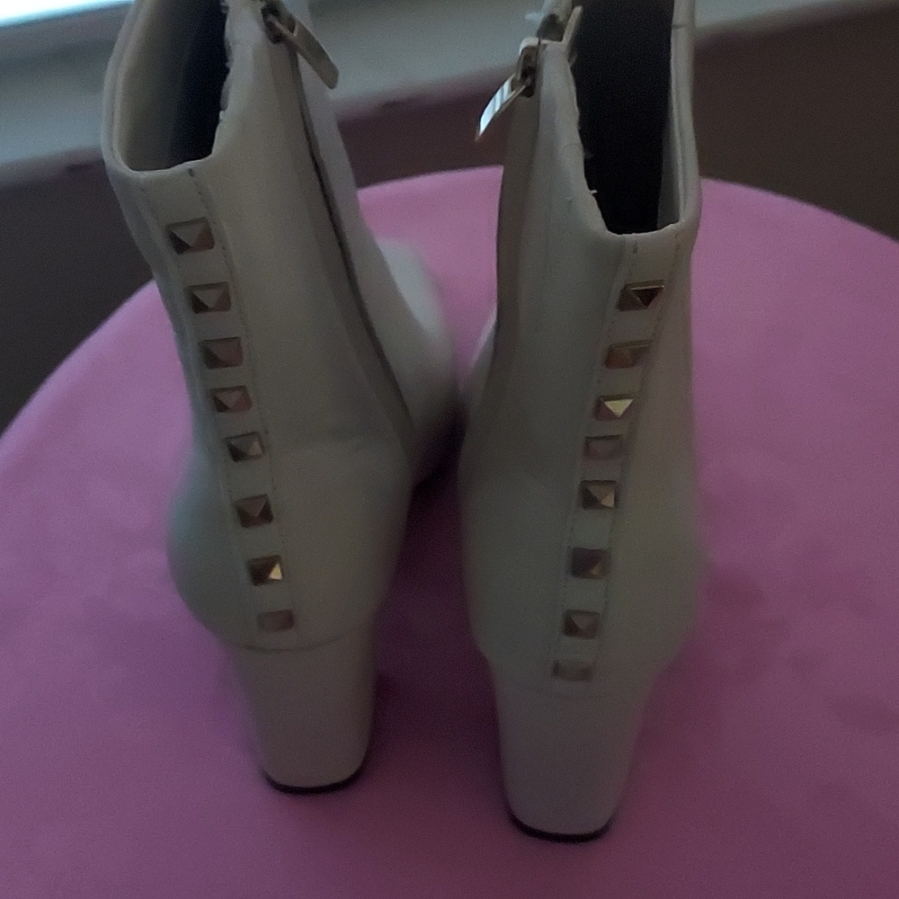 A brand new pair of Nine West size 9.5M booties; stud accent on back of boot